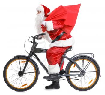 Santa Claus with bag and bicycle on white background�