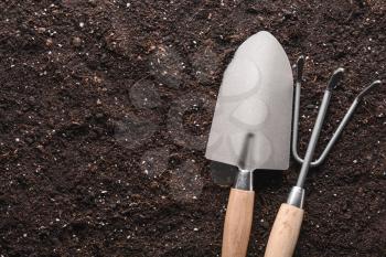 Gardening tools on soil, top view�