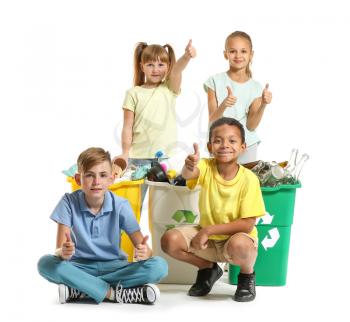 Little children and containers with trash on white background. Concept of recycling�