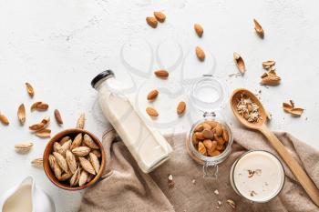 Tasty almond milk on white background�