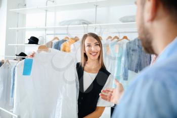 Client taking clothes from modern dry-cleaner's�