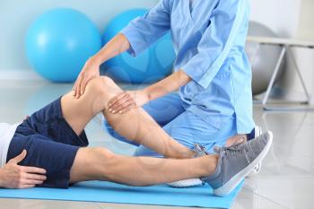 Physiotherapist working with male patient in rehabilitation center�