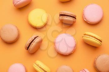 Different tasty macarons on color background�
