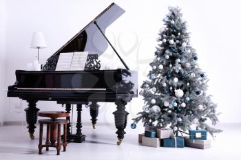 Grand piano in room decorated for Christmas�