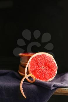 Fresh cut grapefruit on dark background�