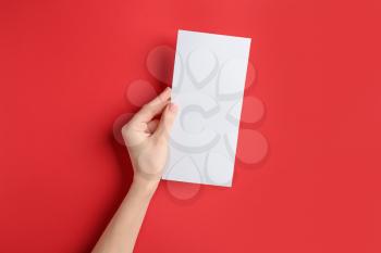 Female hand with blank menu on color background�