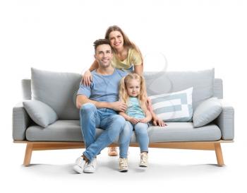 Happy young family with sofa on white background�