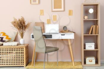 Stylish comfortable workplace with laptop in modern room�