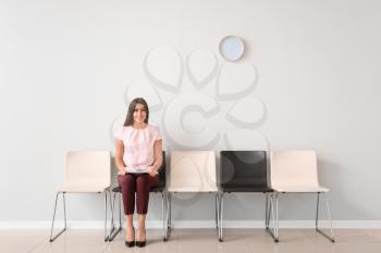 Young woman waiting for job interview indoors�