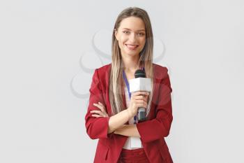 Female journalist on light background�