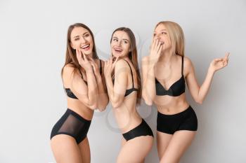 Beautiful young women in underwear on light background�