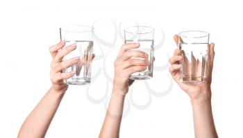Female hands with glasses of water on white background�