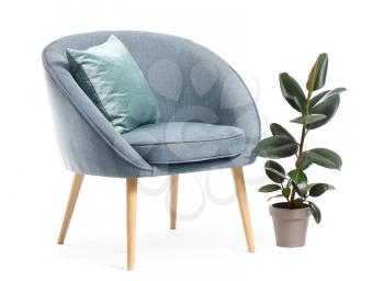Modern armchair and houseplant on white background�