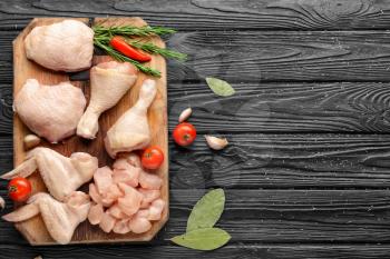 Composition with raw chicken meat on wooden background�