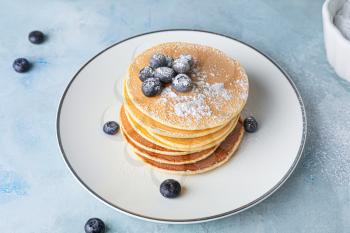 Plate with stack of tasty pancakes on table�