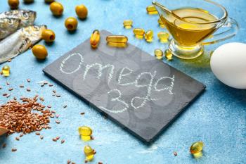 Set of healthy products with high omega 3 and fish oil pills on color background�