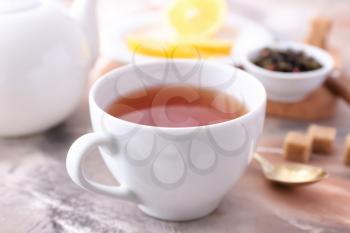 Cup of hot tea on table�