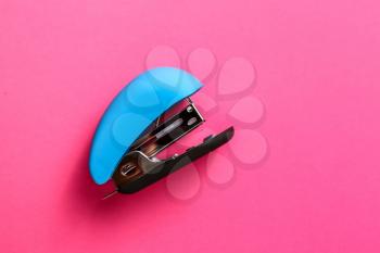 Office stapler on color background�