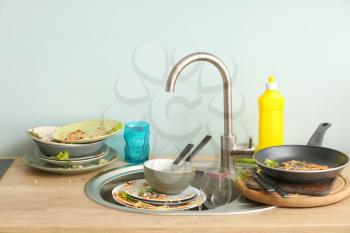 Pile of dirty dishes in kitchen�