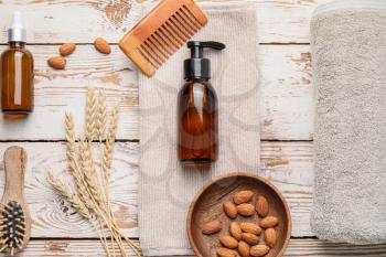Composition with shampoo and natural ingredients on wooden background�