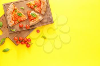 Boards and slices of delicious pizza Margherita on color background�