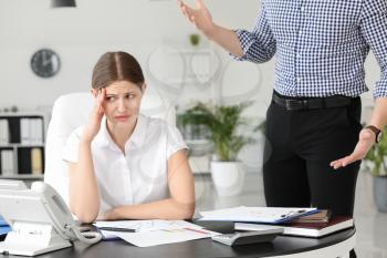 Angry boss scolding his secretary in office�