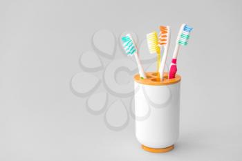 Holder with tooth brushes on light background�
