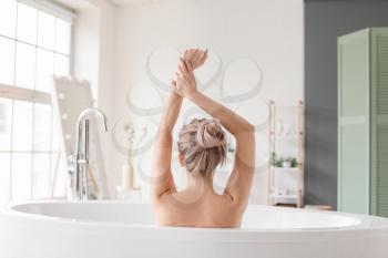 Beautiful young woman taking bath at home�