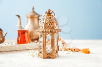 Muslim lamp with tea on white table�