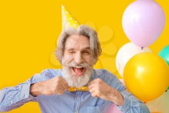 Senior man celebrating Birthday on color background�