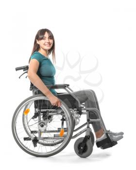Happy young woman in wheelchair on white background�