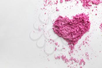 Heart made of crumbled eyeshadows on white background�