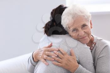 Happy elderly woman with her daughter at home�