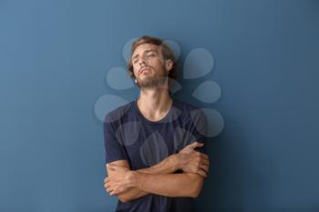 Depressed young man on color background�