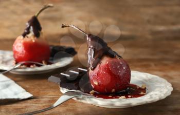 Delicious poached pear in red wine with chocolate sauce on plate�