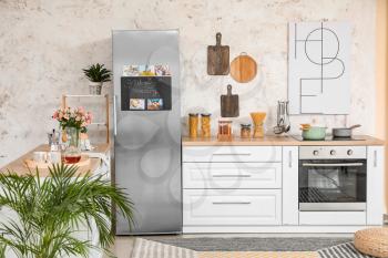 Interior of modern kitchen with refrigerator�
