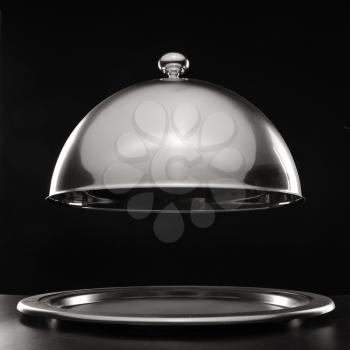 Tray and cloche on dark background�