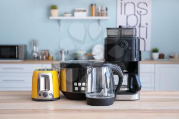 Different household appliances on table in kitchen�