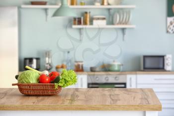 Basket with fresh vegetables on kitchen table�