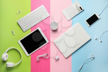 Different modern devices on color background�