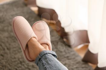 Legs of woman in soft slippers at home�