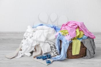 Dirty laundry on floor near light wall�