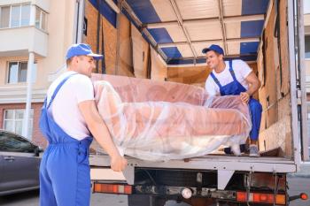 Loaders taking furniture from truck�