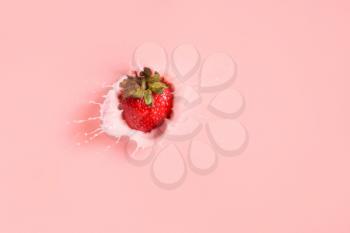 Falling of fresh strawberry into milk�