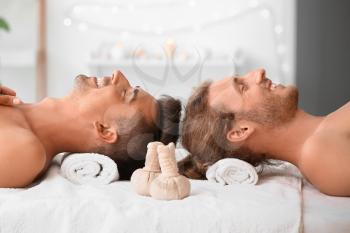 Happy gay couple relaxing in spa salon�