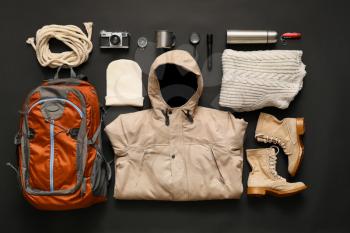 Set of items and clothes for hiking on dark background�