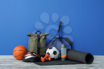 Set of sport equipment on floor near color wall�