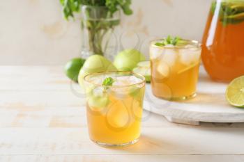 Glasses of tasty ice tea on wooden background�