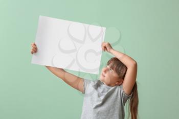Little girl with blank paper sheet on color background�