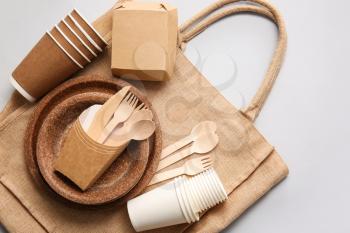 Eco tableware and bag on light background�